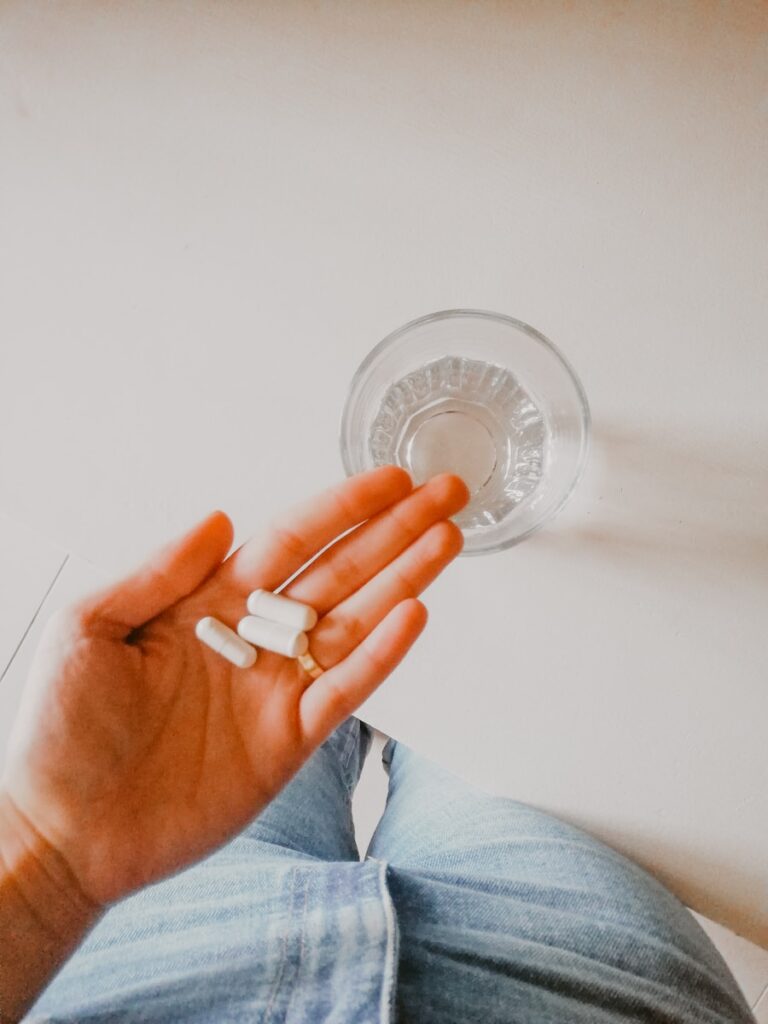 person holding white medication pill