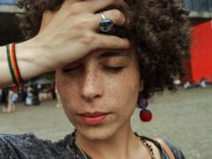 Close-up Photo of Woman with Her Eyes Closed Holding Her Forehead