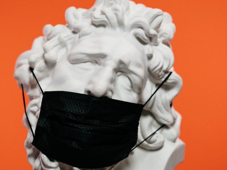 White Ceramic Sculpture With Black Face Mask