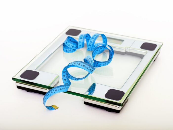 Blue Tape Measuring on Clear Glass Square Weighing Scale