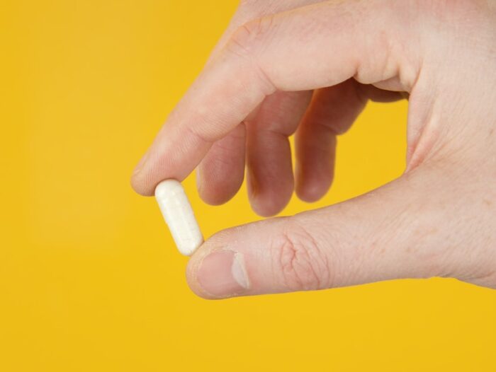 person holding white cigarette stick