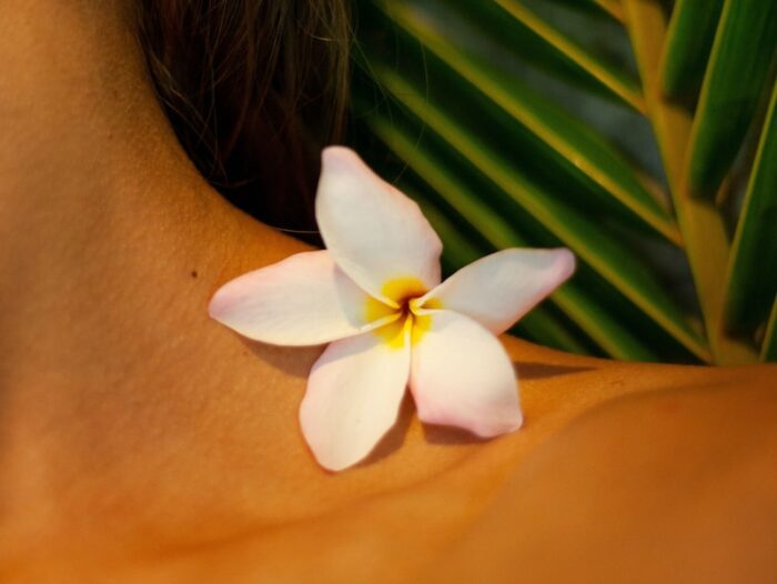 white flower on womans breast