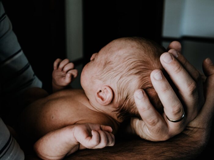 a man holding a baby in his arms